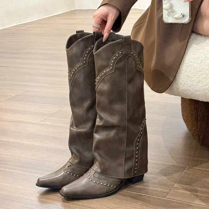 Dark brown knee high western boots with stud trim and pointed toes