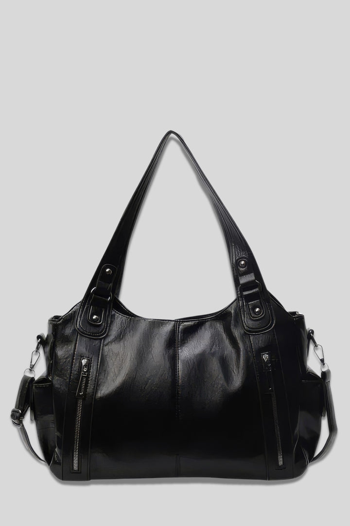 Front view of the Grace Everyday City Bag in black vegan leather with shoulder straps and outer zip pockets