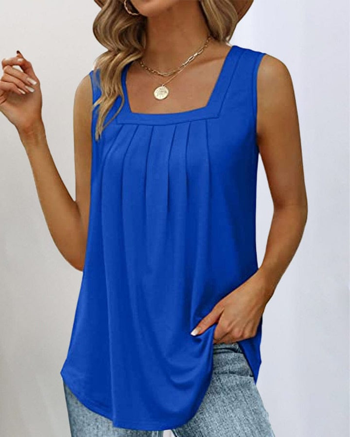 Three quarter view of a woman wearing a blue sleeveless square neck tank top with front pleats