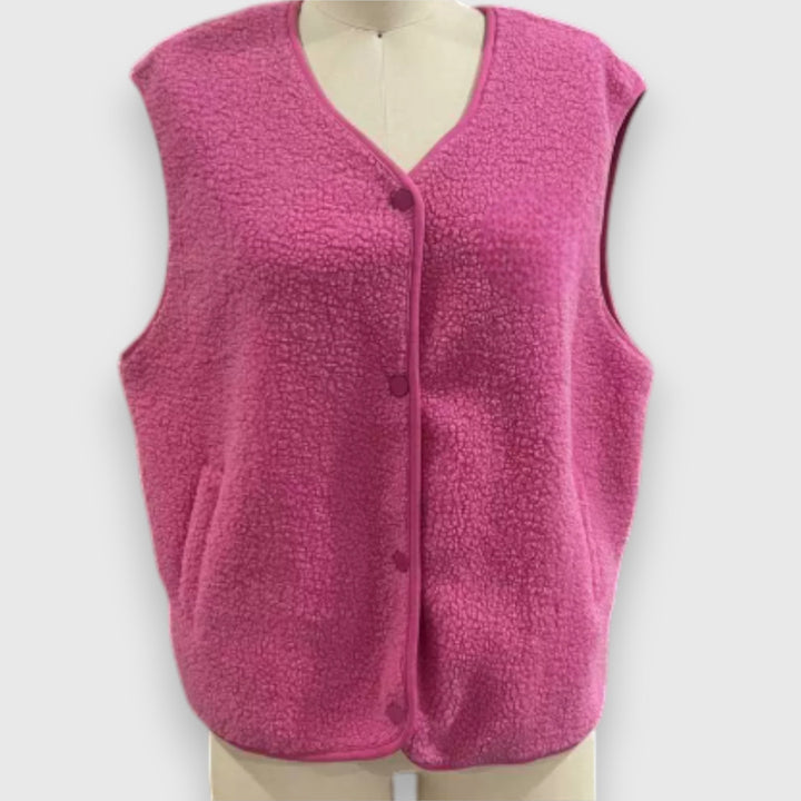 Front view, bright pink cosy fleece vest on a mannequin, showing the soft sherpa texture and button details