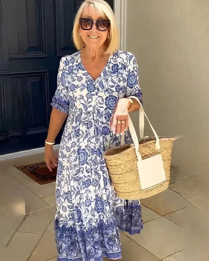 Elegant Summer Dress worn by model, front view, with blue and white floral print and straw bag