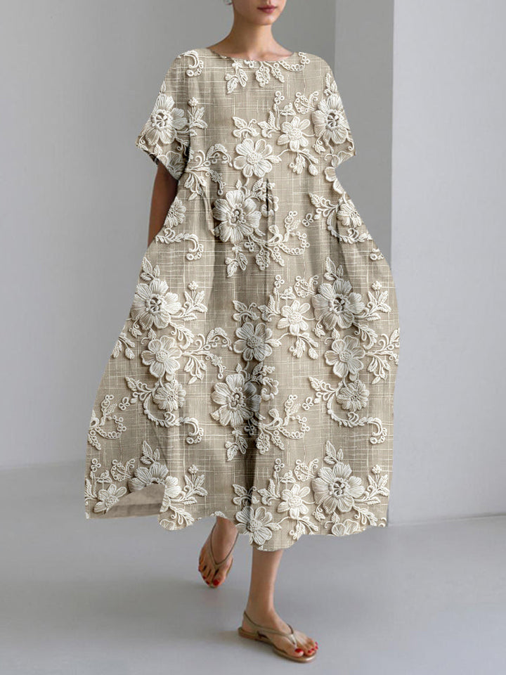 Front view of a model wearing a taupe floral print dress with white embroidery and pockets