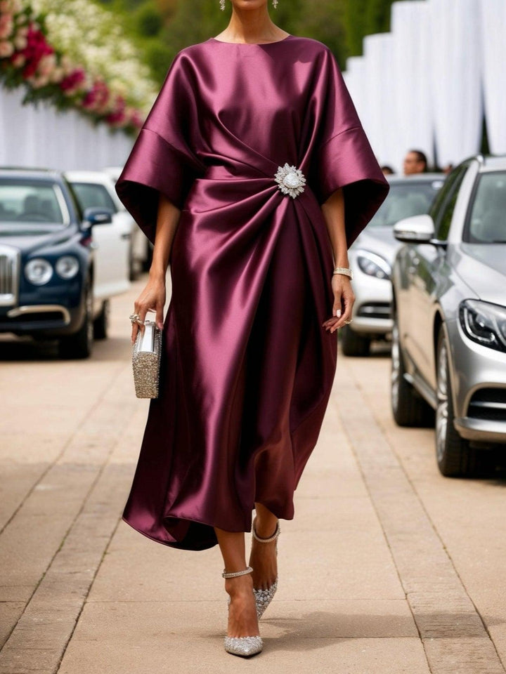 Burgundy shimmer satin long dress with a sparkly brooch, front view