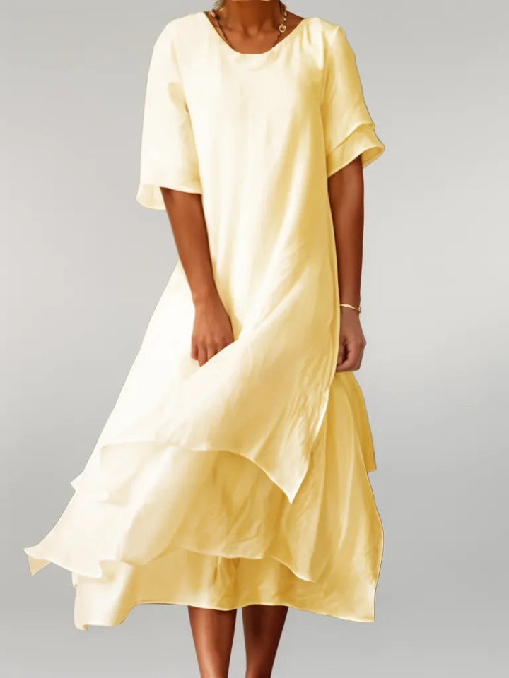 Front view of the Oriana Cotton Maxi Dress in yellow, worn by a model, showing the layered skirt detail