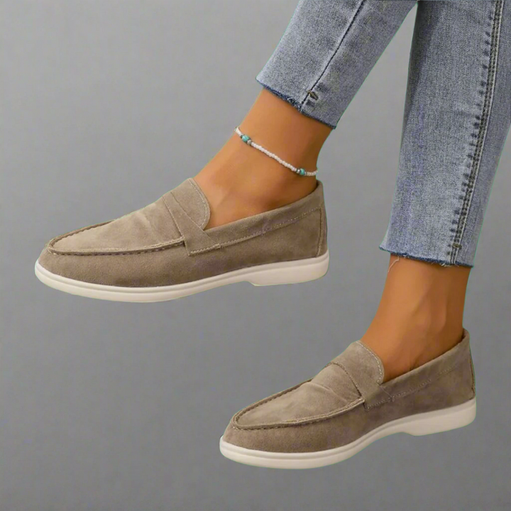 Ellis Elegant Flat Shoes worn by model, a pair of taupe suede slip-on flats with white soles