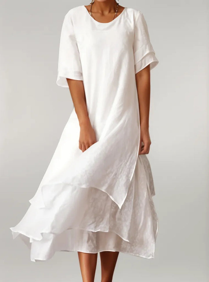 Oriana Cotton Maxi Dress in white, worn by a model, showing layered skirt and flowy fabric movement