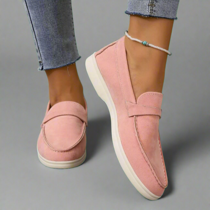 Front view of pink suede Ellis Elegant Flat Shoes with white soles worn with blue jeans