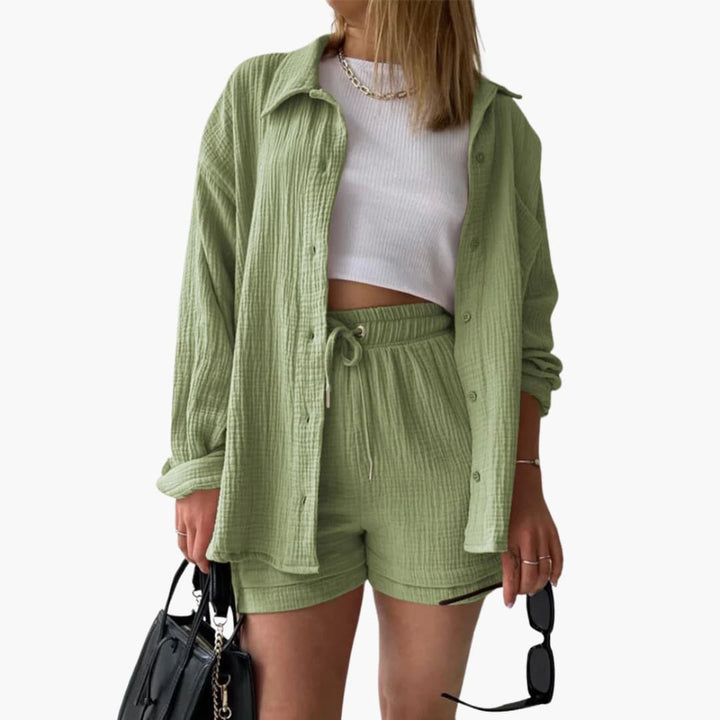Brianna elegant summer two piece suit, front view worn by model, with white crop top, black bag and sunglasses