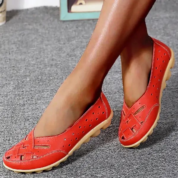 Worn by model, red breathable leather loafers with woven toe and perforated sides on a grey carpet