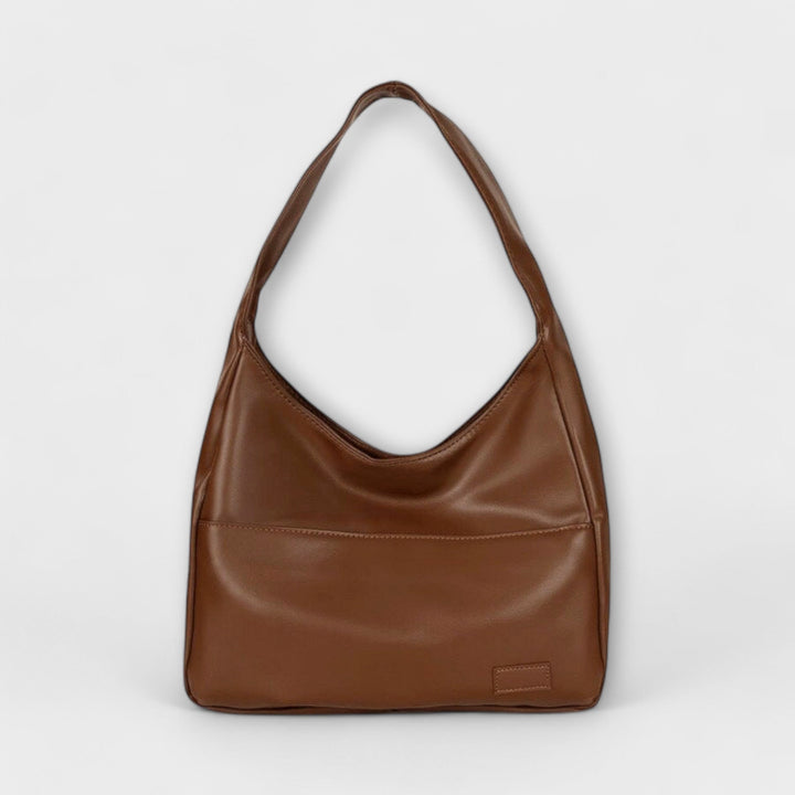 Front view of a brown PU leather shoulder bag with a single strap and a subtle front pocket