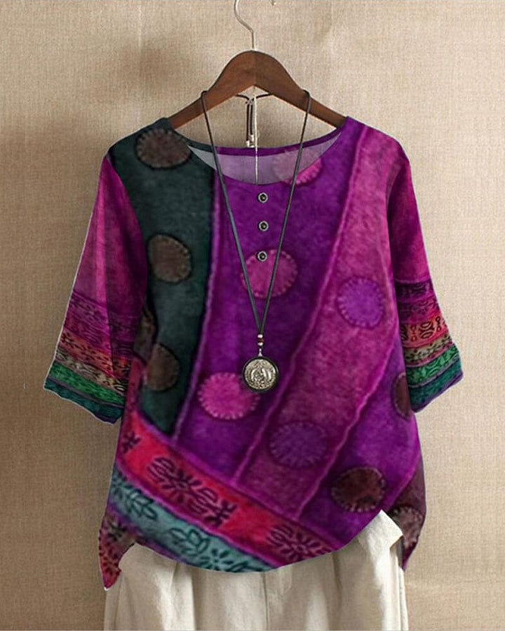 Front view of a Lacey Casual Blouse with a vibrant digital print, half sleeves, and a long necklace