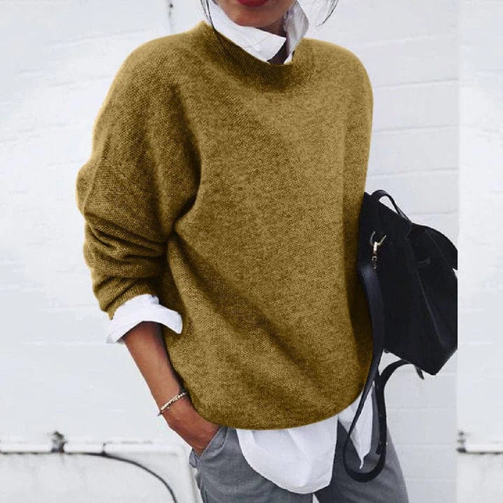 Olive green oversized knit jumper over a white shirt, close up view