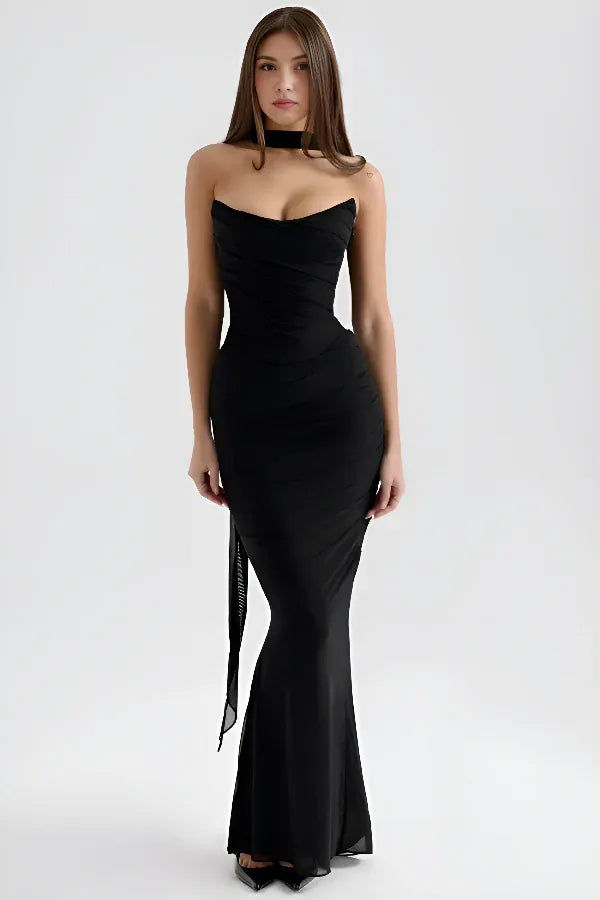 Front view worn by model, a black strapless maxi dress with a sweetheart neckline and sheer neck scarf