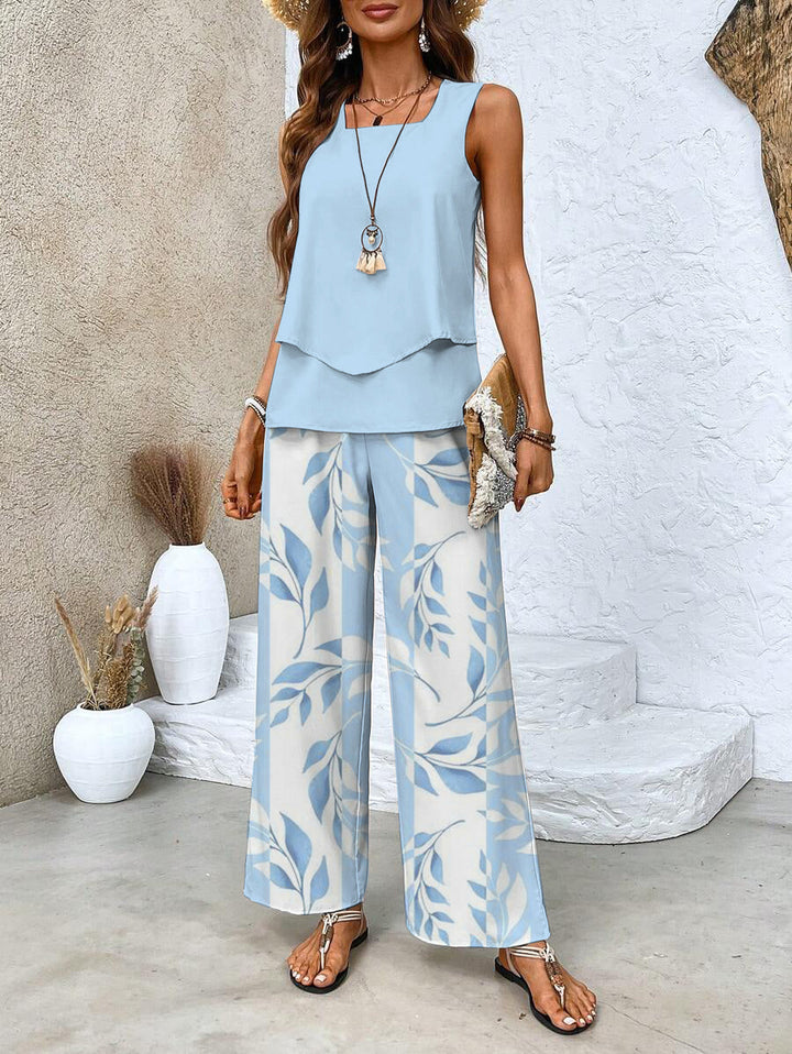 Front view of a woman wearing a blue square neck vest and floral stripe two-piece set