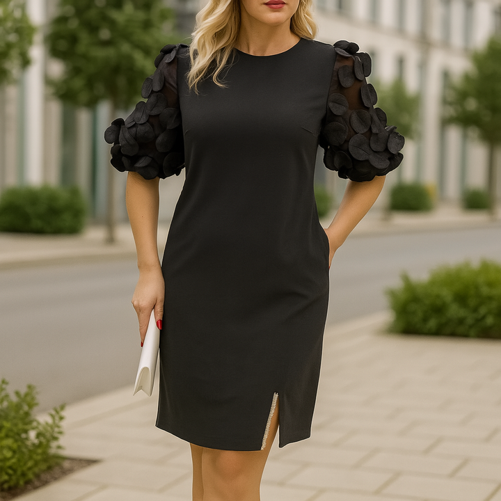 Front view of a woman wearing an elegant black dress with sheer five-quarter sleeves and garden collar detail
