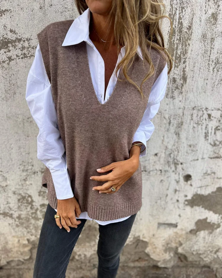 Mocha brown V neck knit vest worn over a white shirt