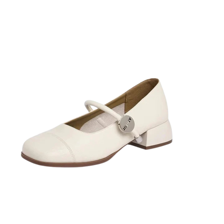 Side view, a single cream square toe Mary Jane shoe with a silver charm on the strap