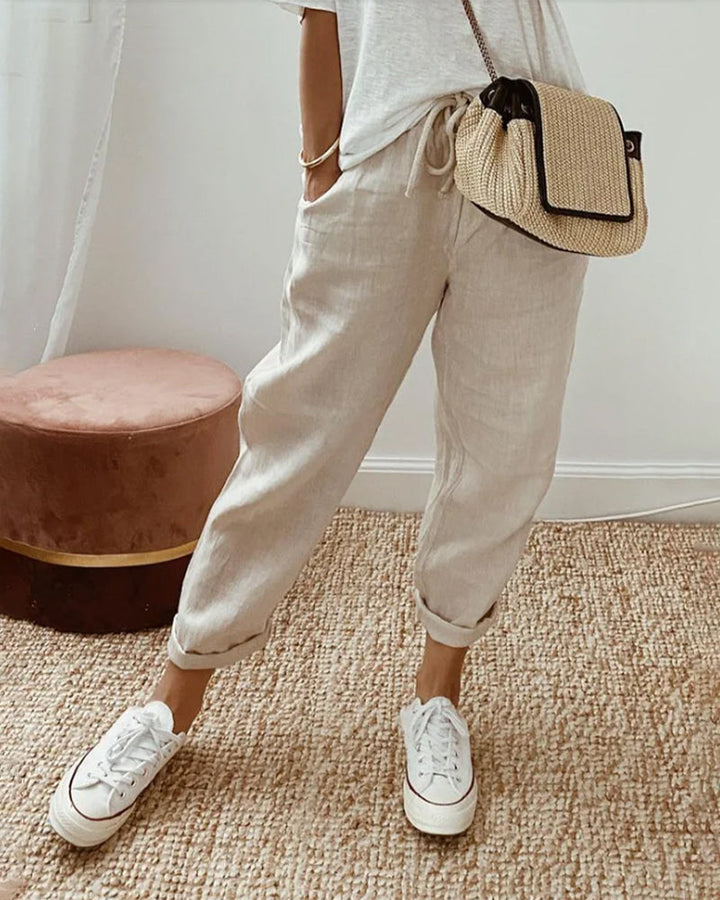 Carter Sweat-Wicking Linen Pants worn by model, cropped view of legs and torso, hand in pocket