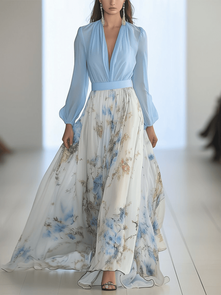 Front view of a model wearing a long dress with a light blue top and a flowing floral print skirt