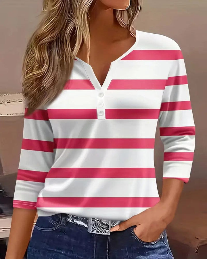Front view of a model wearing a white and pink striped V-neck long sleeve shirt with three white buttons