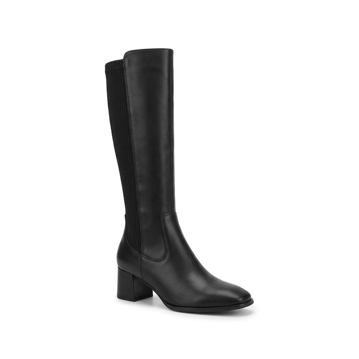 Three quarter view of a black genuine leather knee-high boot with a block heel and ribbed elastic panel