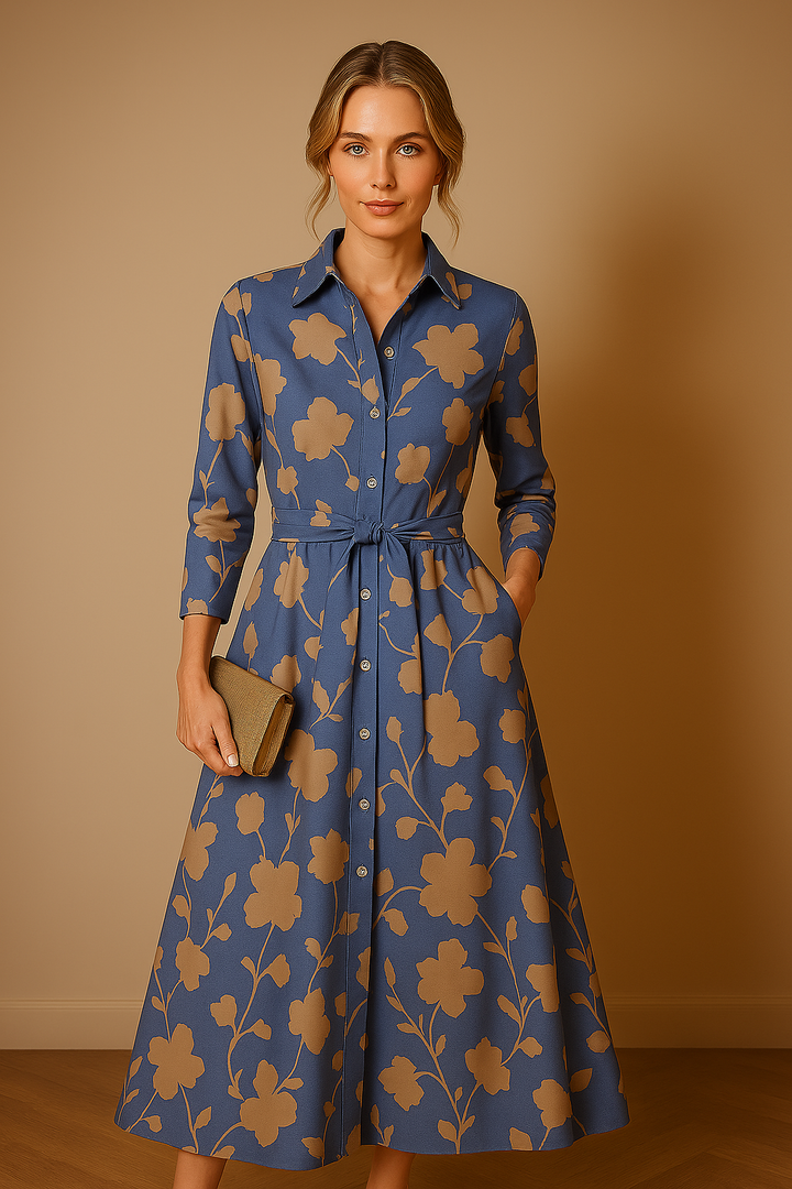 Front view of a model wearing a blue and tan floral midi shirt dress with a tie waist and pockets
