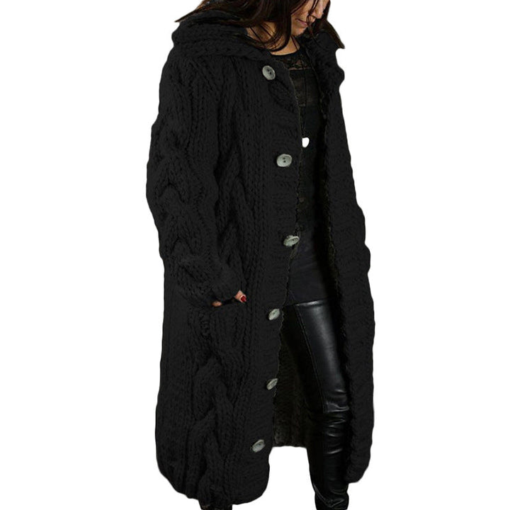 Front view, model wearing a long black oversized wool blend cardigan with chunky cable knit, hood and buttons