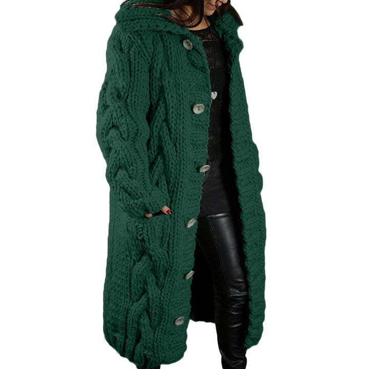 Front view, model wearing a long green oversized wool blend cardigan with chunky cable knit, hood and buttons