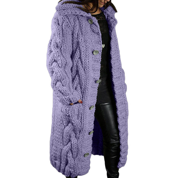 Side view, model wearing a long purple oversized wool blend cardigan with chunky cable knit and grey buttons