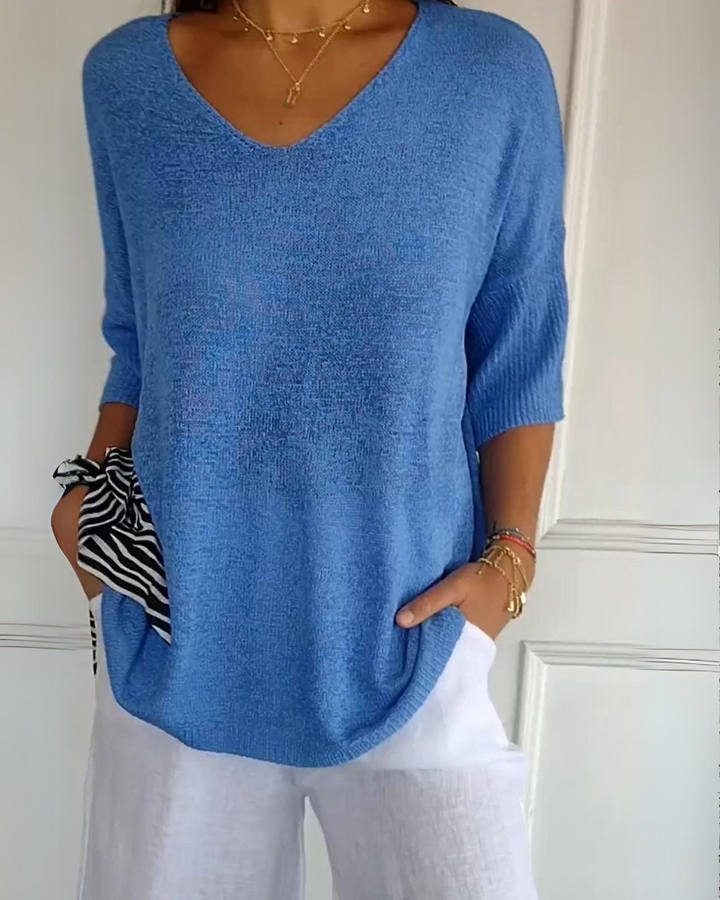 Cornflower blue breathable cotton top with a V neckline and white trousers