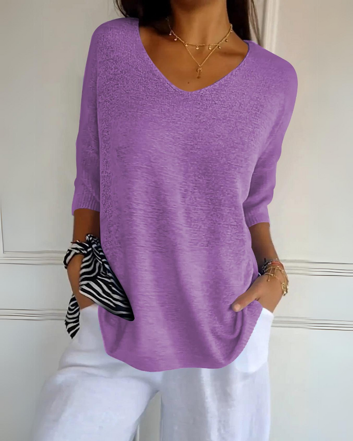 Light purple breathable cotton top with a V neck and white trousers