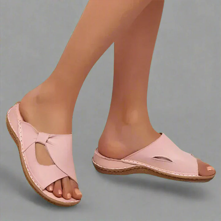 Vera premium leather arch support sandals, worn by model, showing the front view of the left foot and side of the right