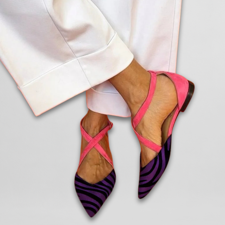Pink and purple zebra print pointed toe flats with white trousers