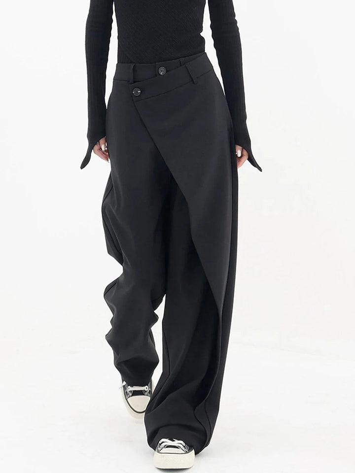 Front view, model in avant-garde tailored pants with a unique wrap waist, baggy fit, and visible buttons