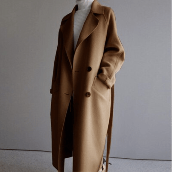 Three quarter view of a camel Florence premium blend wool coat, worn open over a white turtleneck
