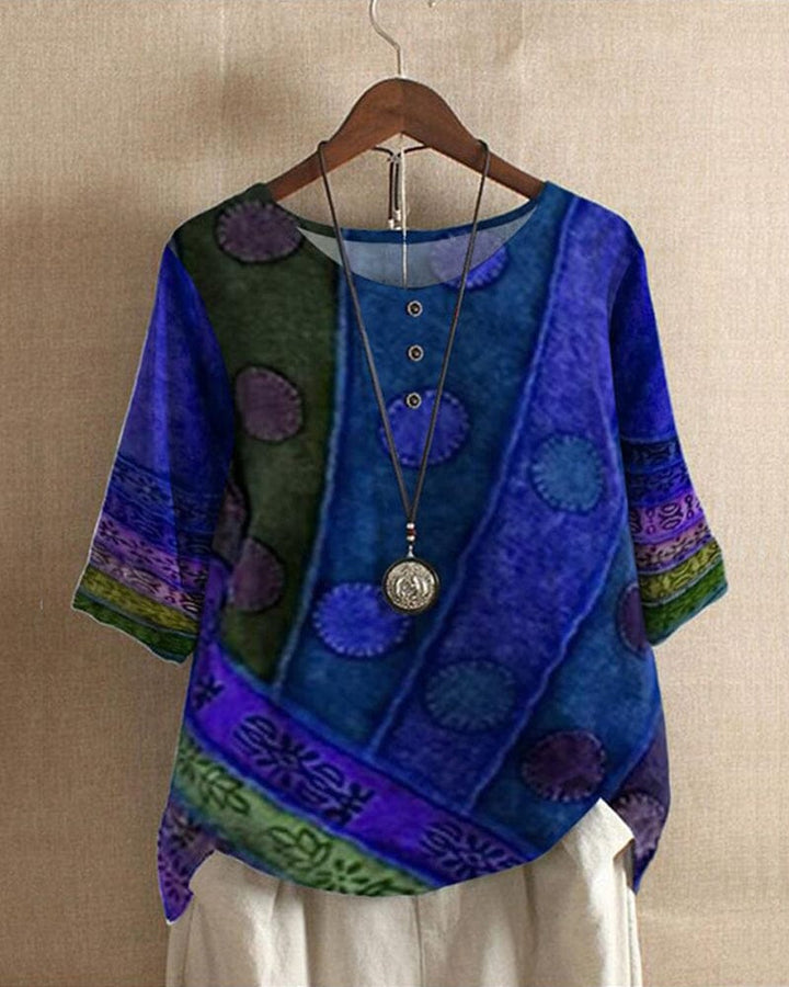 Front view of a Lacey Casual Blouse with half sleeves, digital print, buttons, and a long pendant necklace