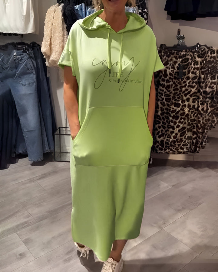 Front view of a model wearing a lime green hooded sweatshirt dress with &