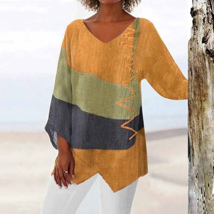 Front view of a model wearing the tricolour shirt with orange, green, and dark grey colour blocks and zigzag stitching