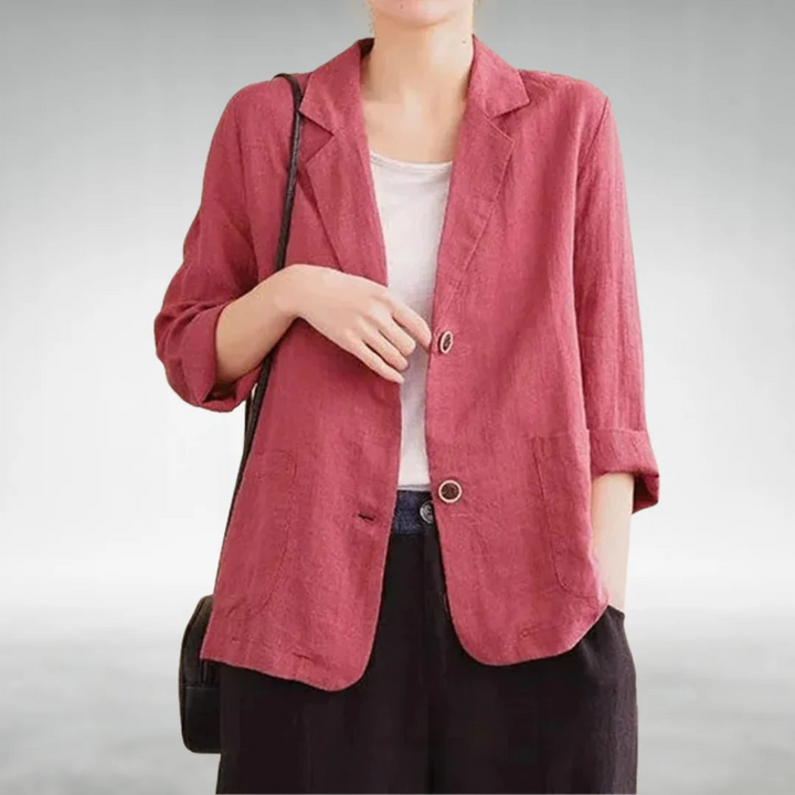 Front view of a model wearing a rose pink casual chic blazer with two buttons and rolled up sleeves