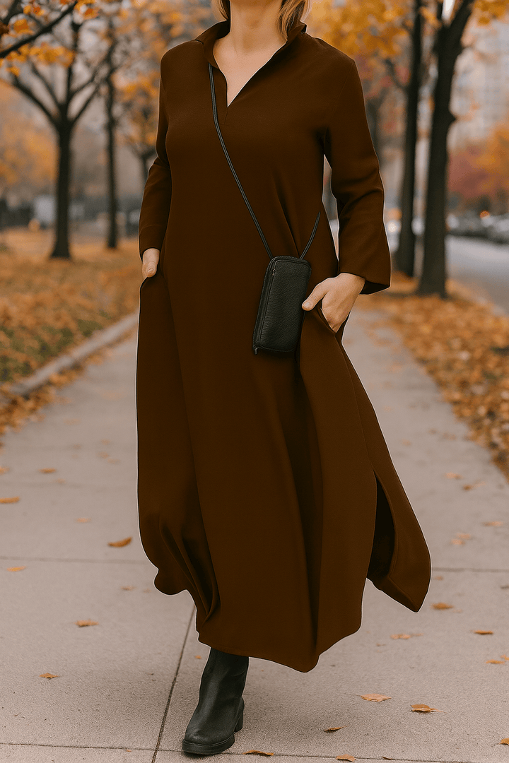Close up front view of a model wearing a black V neck oversized long dress with side splits
