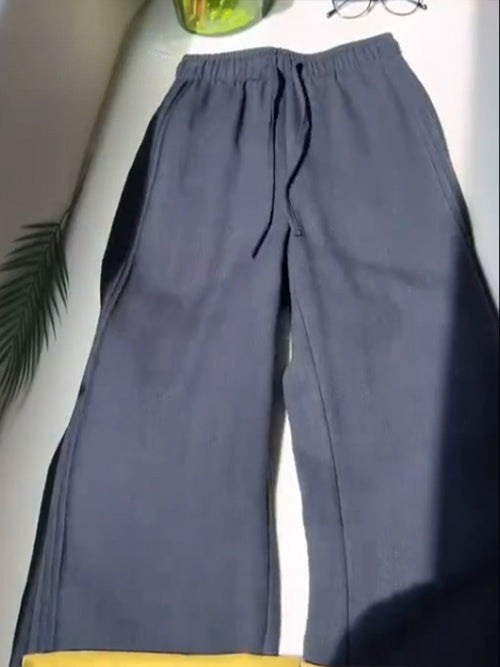 Flat lay of dark grey Tencel linen wide leg casual pants with a drawstring and elasticated waist