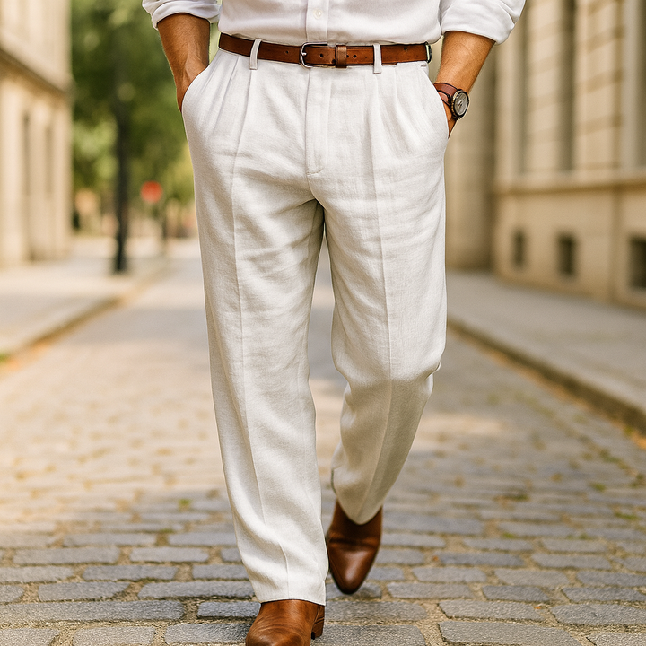 Close up of the front of classic cotton linen pants in beige, worn by a model walking on a cobblestone street