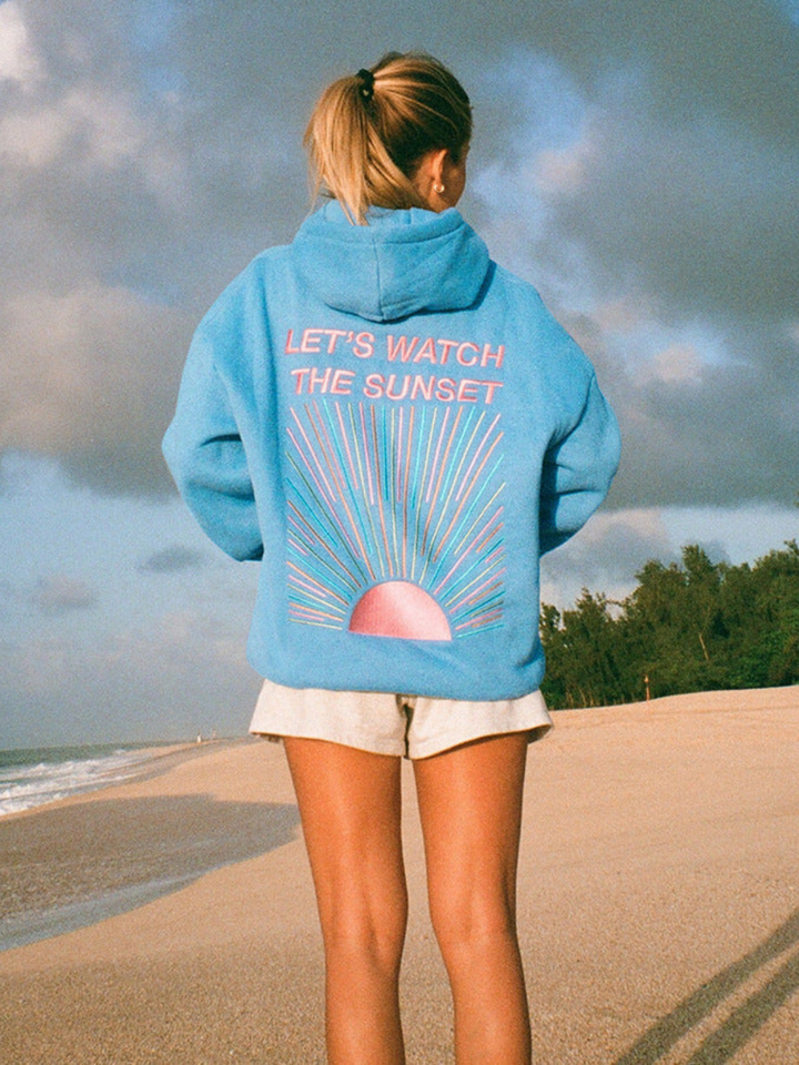 Back view of model wearing an oversized graphic print hoodie with "LET&