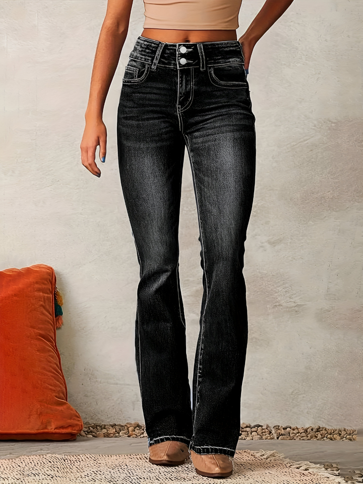 Washed black high waisted flared jeans worn with a beige top