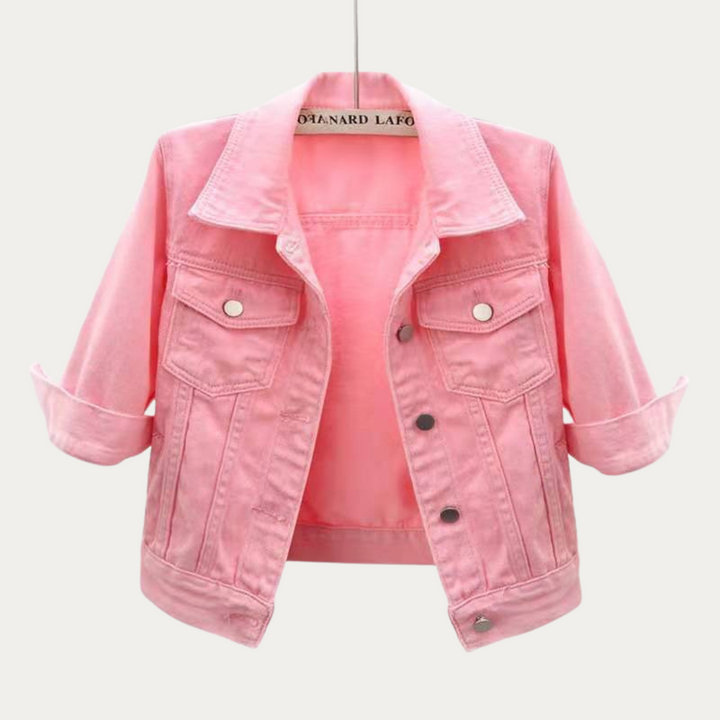Front view of a pink colourful denim jacket with rolled up three quarter sleeves, on a hanger