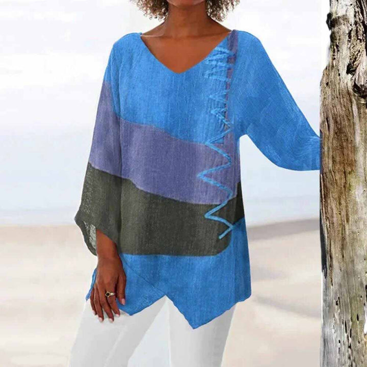 Front view of a model wearing the tricolour shirt with blue, purple, and dark grey colour blocks and zigzag stitching