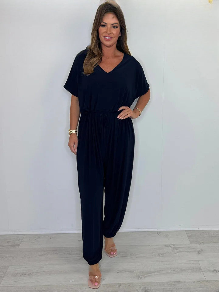 Navy blue V neck jumpsuit with a tie waist and wide legs