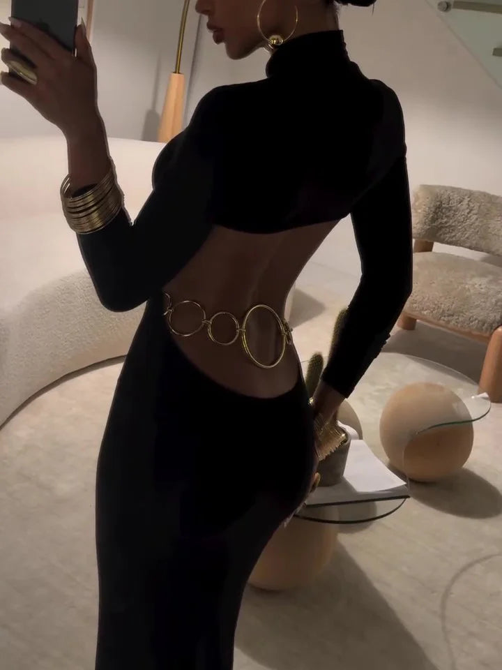 Back view worn by model, black cut-out turtleneck maxi dress with gold chain detail, long sleeve