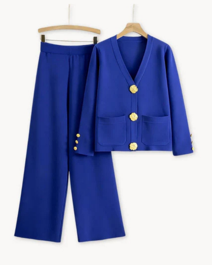 Front view of a luxurious knitwear set in blue, featuring a cardigan with gold buttons and wide leg trousers