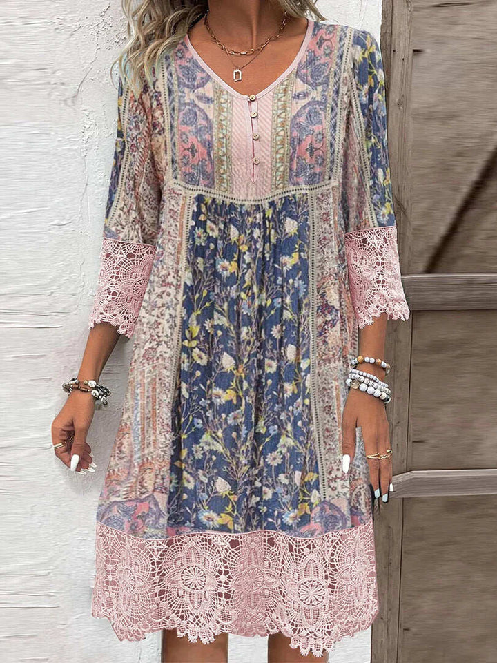 Vintage printed lace dress worn by model, showing the front with a floral pattern and lace trim